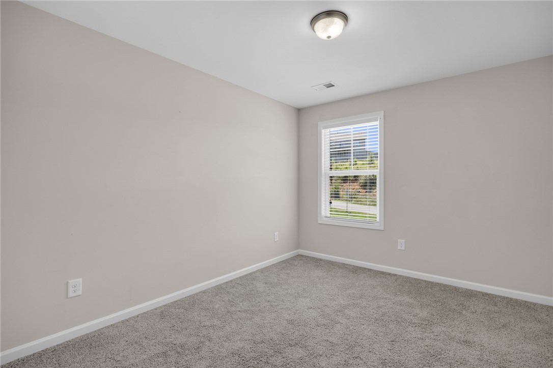 430 Johnson Road Central, SC 29630 - Photo 18 of 36 A well-lit bedroom features plush carpeting and a bright window.