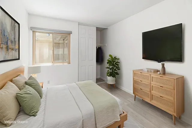 a bedroom with a bed and a flat screen tv