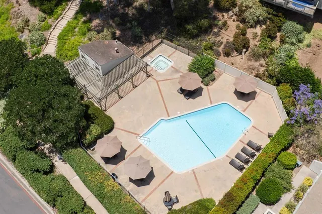 an aerial view of a house with a yard basket ball court and outdoor seating