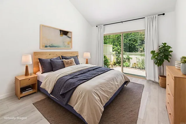 a bedroom with a large bed and a large window