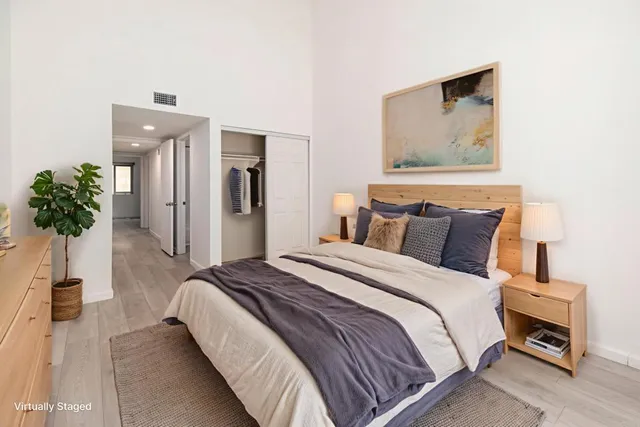 a bedroom with bed and a potted plant