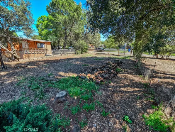 a view of backyard of house with green space