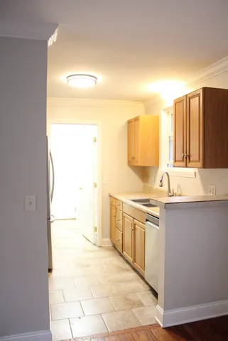 a large kitchen with a sink and cabinets