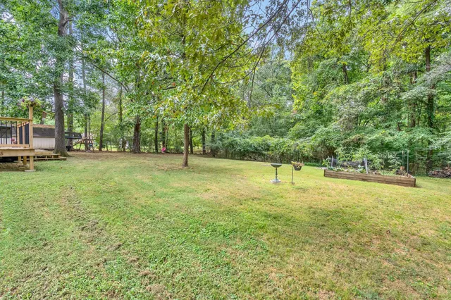 a swimming pool with trees in the background