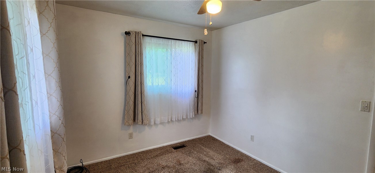 5852 Lake Road Mentor, OH 44060 - Photo 20 of 45 Carpeted spare room with ceiling fan