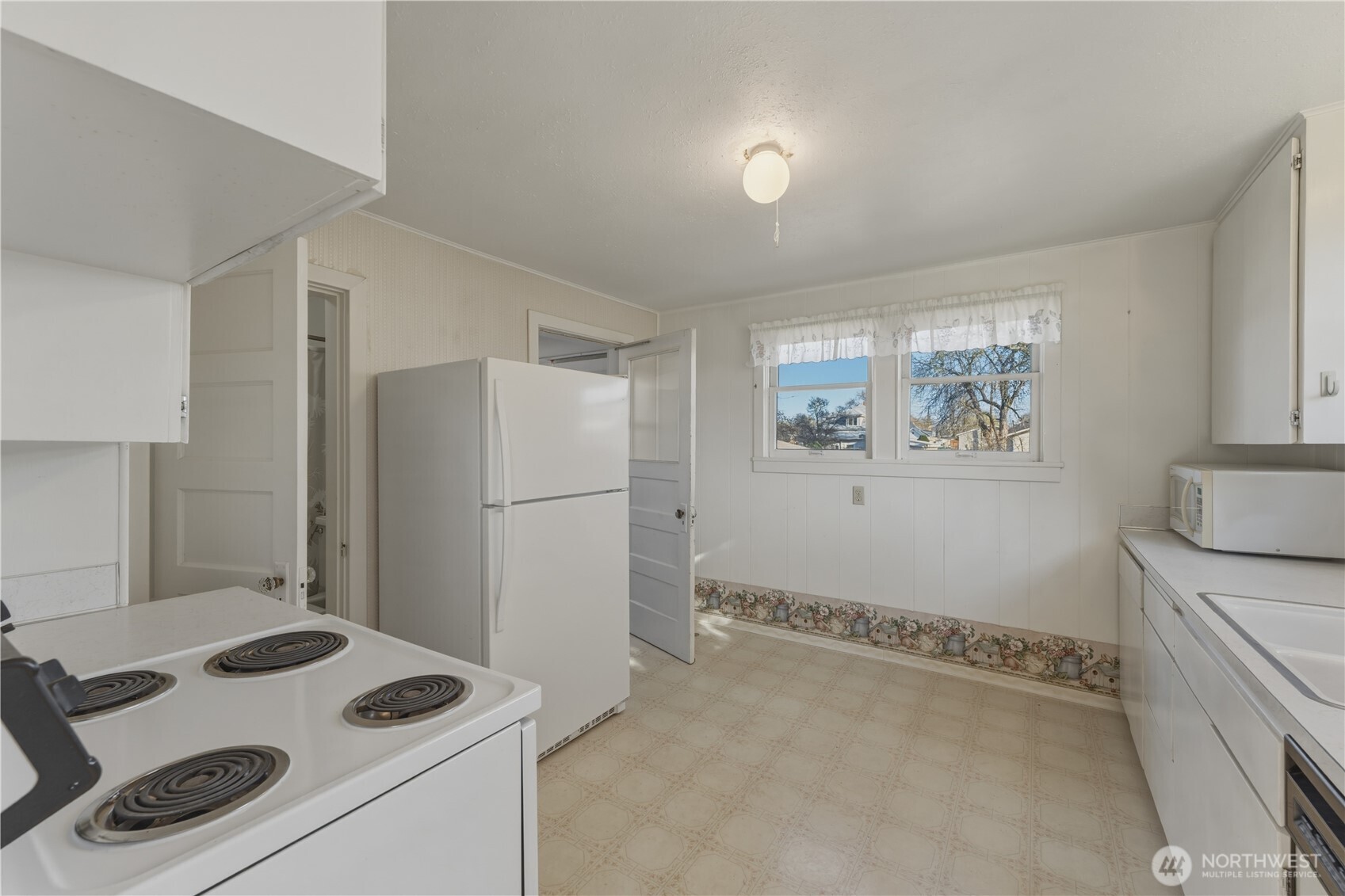 116 Southwest 9th Street College Place, WA 99324 - Photo 12 of 23 a kitchen that has a sink a stove and a refrigerator