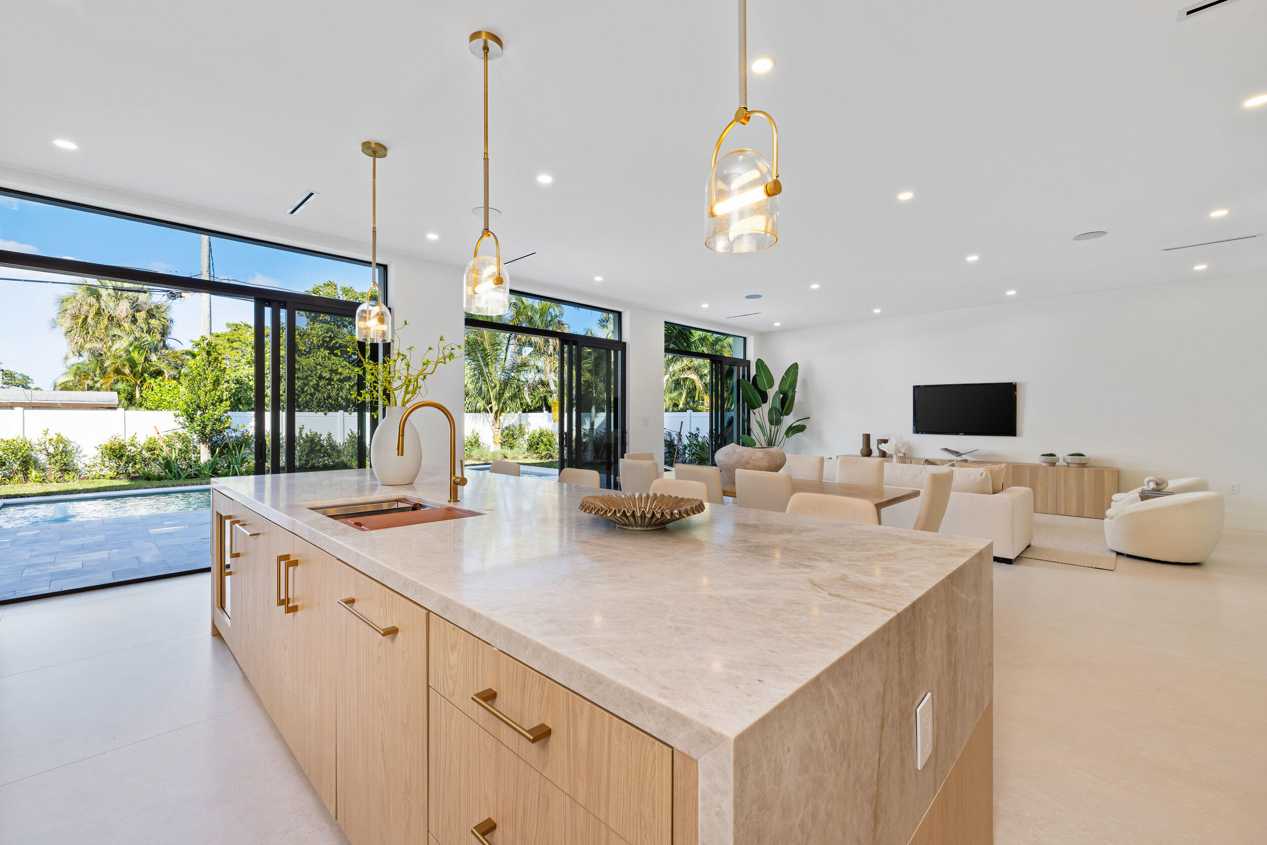 101 Northwest 17th Street Delray Beach, FL 33444 - Photo 11 of 46 a kitchen with stainless steel appliances granite countertop a sink a stove and a wooden floor
