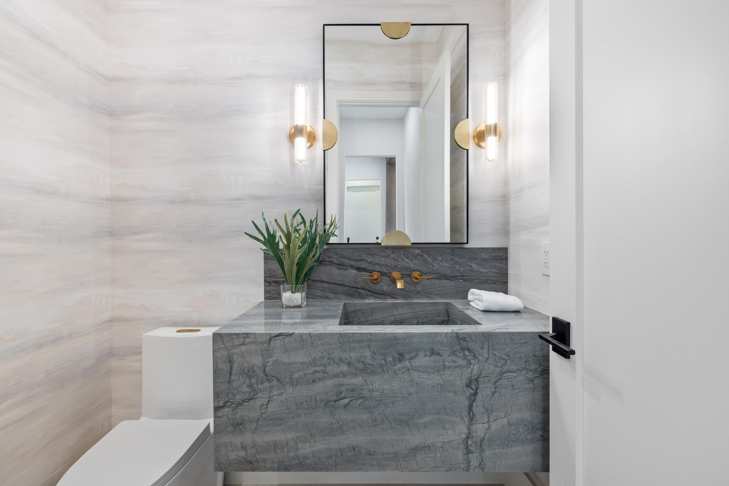 101 Northwest 17th Street Delray Beach, FL 33444 - Photo 13 of 46 a bathroom with a granite countertop sink a toilet and mirror