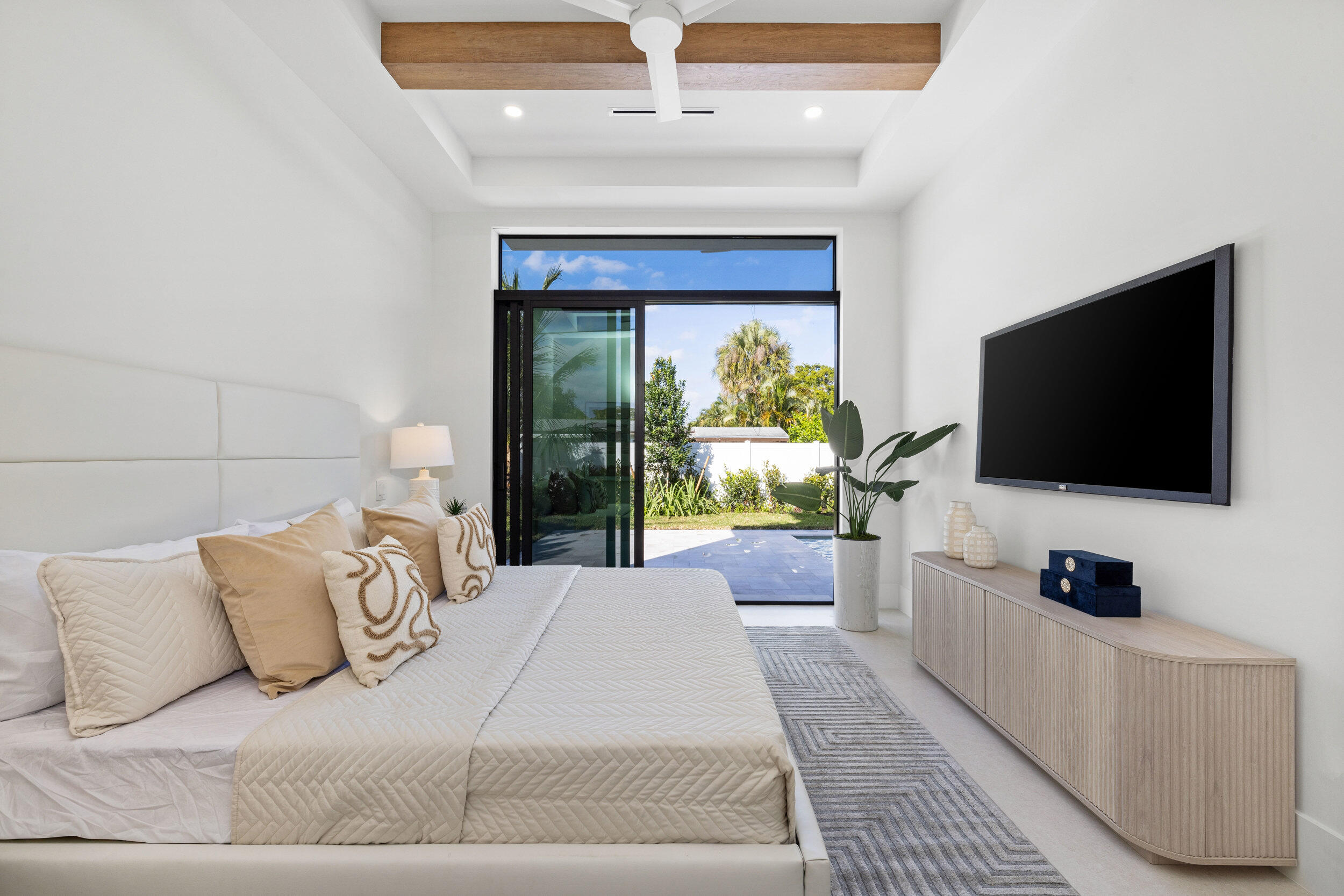 101 Northwest 17th Street Delray Beach, FL 33444 - Photo 27 of 46 a spacious bedroom with a large bed and a flat screen tv