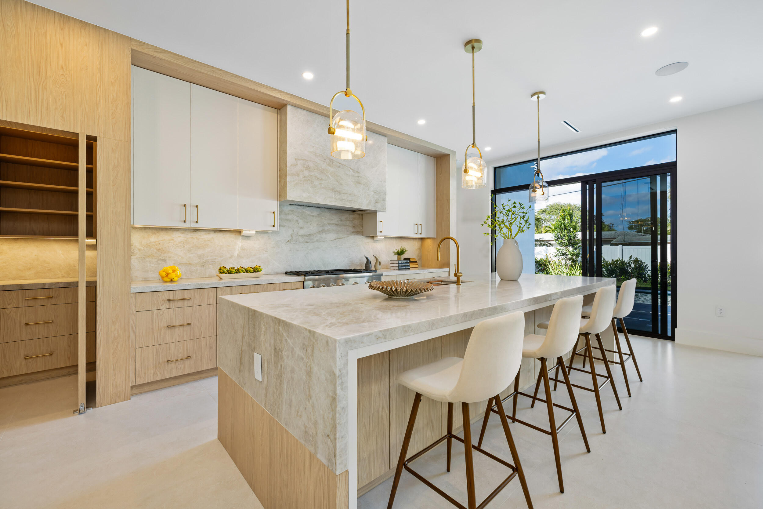 101 Northwest 17th Street Delray Beach, FL 33444 - Photo 10 of 46 a kitchen with a table chairs refrigerator and microwave