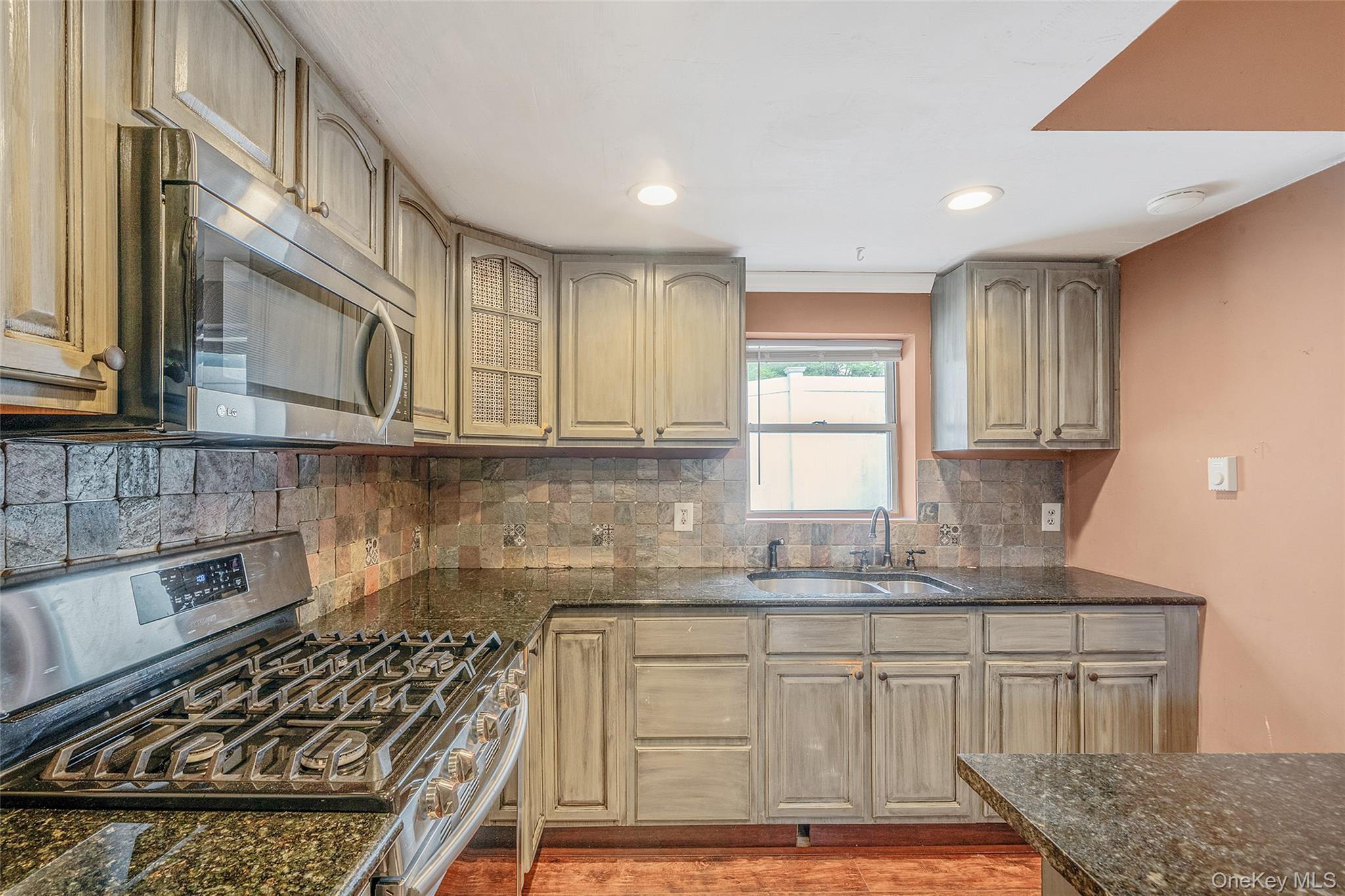 93 Maple Road Kings Park, NY 11754 - Photo 10 of 24 a kitchen with stainless steel appliances granite countertop a sink stove and cabinets