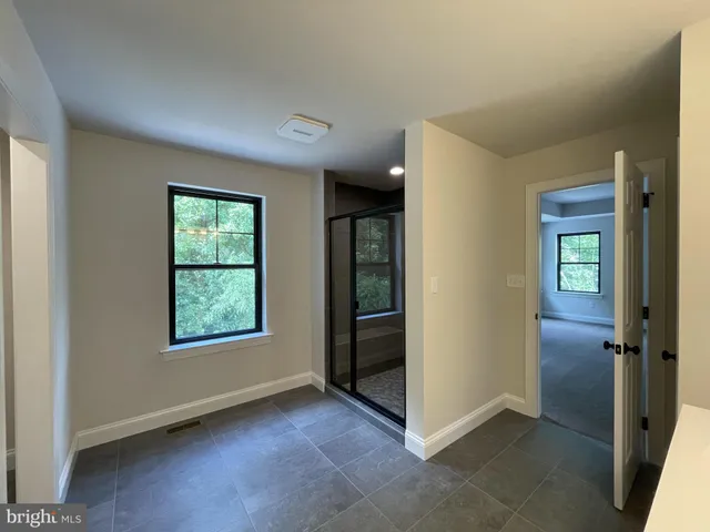 an empty room with windows and closet