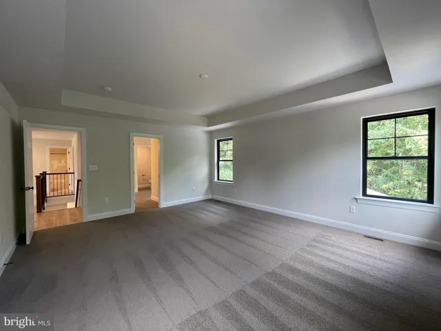 an empty room with windows and closet