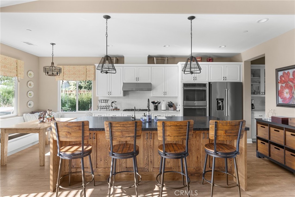 585 Valley Oak Road Solvang, CA 93463 - Photo 12 of 36 a dining table chairs wooden floor and windows