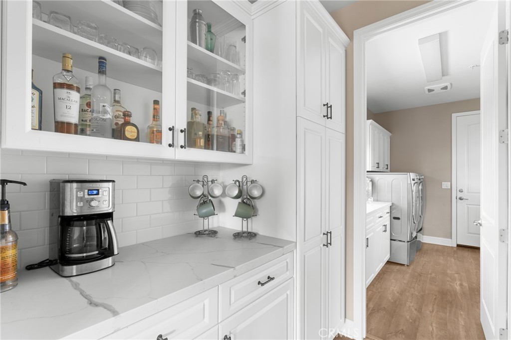 585 Valley Oak Road Solvang, CA 93463 - Photo 15 of 36 a hallway with white cabinets and wooden floor