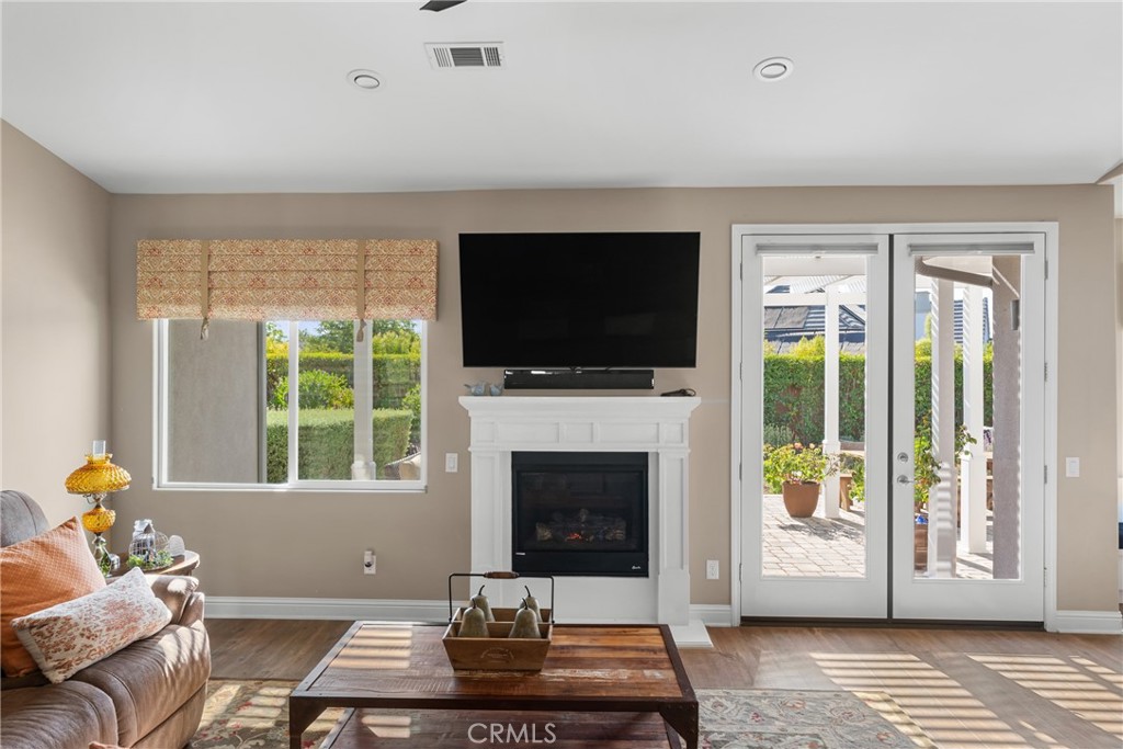 585 Valley Oak Road Solvang, CA 93463 - Photo 23 of 36 a living room with furniture a flat screen tv and a fireplace