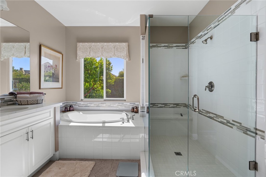 585 Valley Oak Road Solvang, CA 93463 - Photo 29 of 36 a bathroom with a granite countertop sink a window and a mirror