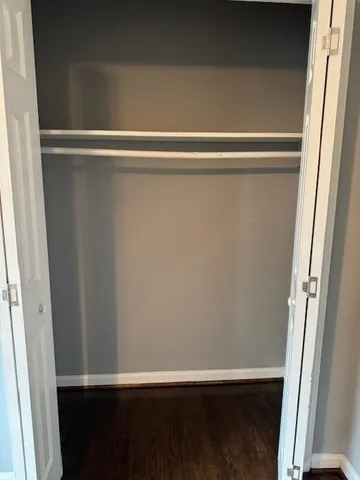 a view of a closet with wooden floor