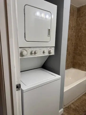 a bathroom with a sink and mirror with bathtub