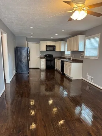 a view of kitchen with microwave and cabinets