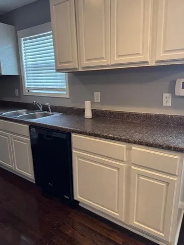 a kitchen with granite countertop wooden cabinets and a hard wood floors