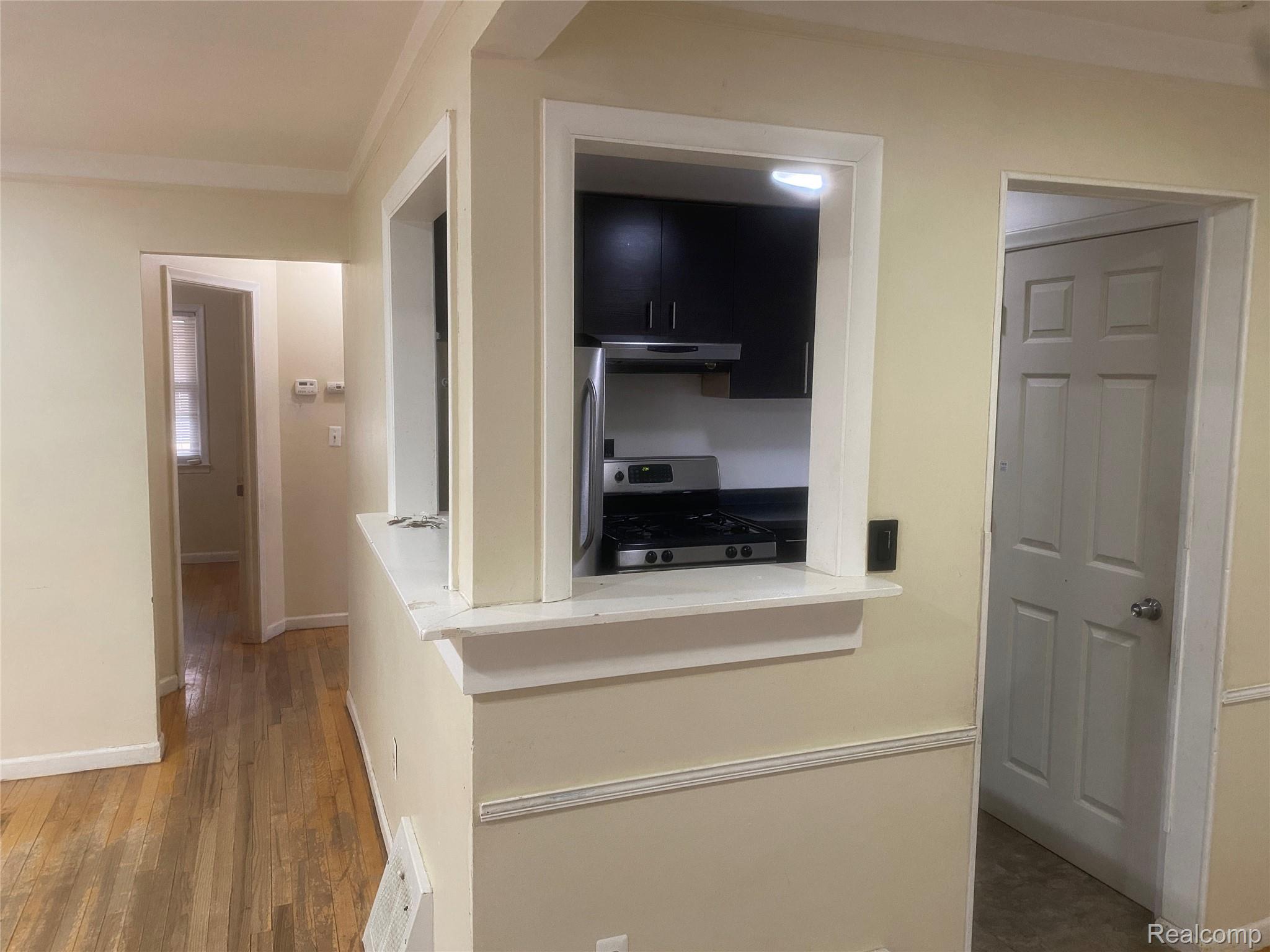 180 West Rutgers Avenue Pontiac, MI 48340 - Photo 8 of 33 Hallway featuring crown molding and dark wood finished floors