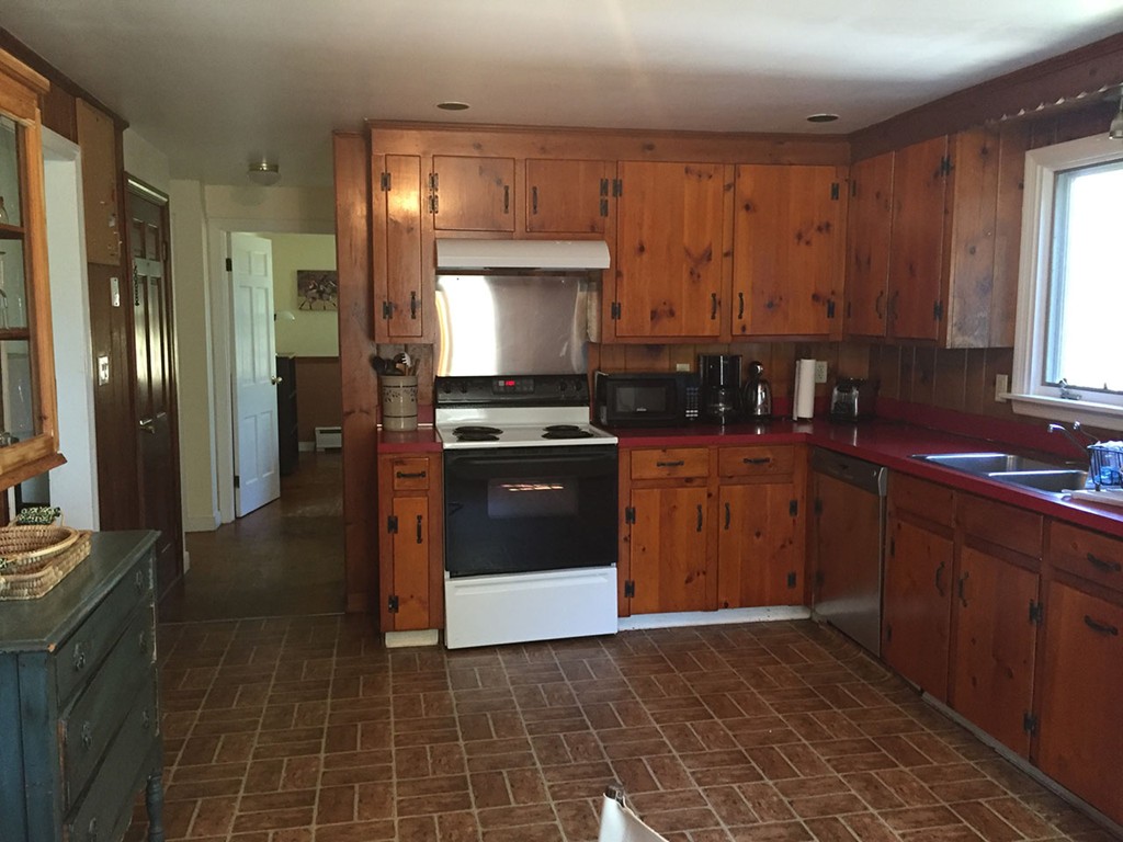 6 Chebacco Road Ipswich, MA 01938 - Photo 9 of 11 a kitchen with a sink a stove and cabinets