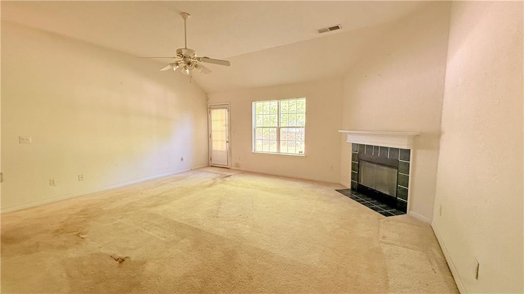 65 Lakeridge Court Covington, GA 30016 - Photo 10 of 17 an empty room with windows and fireplace