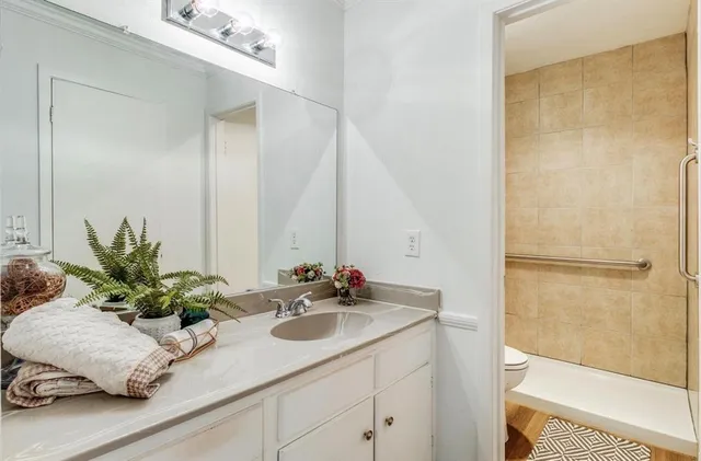 a bathroom with a sink a shower and a mirror