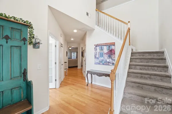 a view of entryway and hall with wooden floor