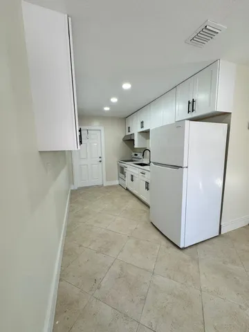 a view of a kitchen with a sink and an oven