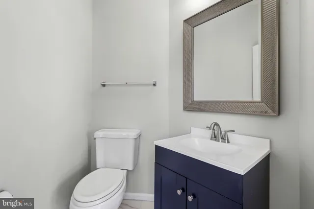 a white toilet sitting next to a bathroom sink