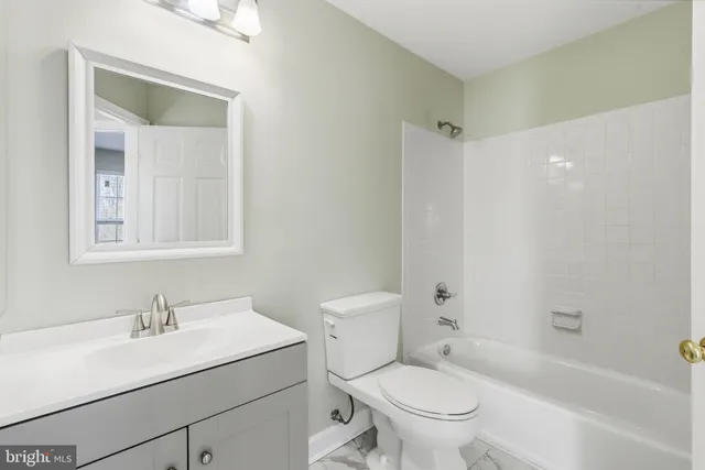 a bathroom with a sink toilet vanity and tub