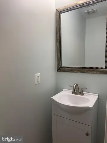 a bathroom with a sink and mirror