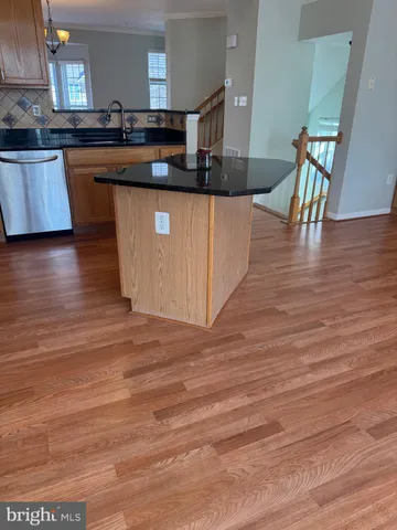 a kitchen with stainless steel appliances granite countertop a sink and cabinets