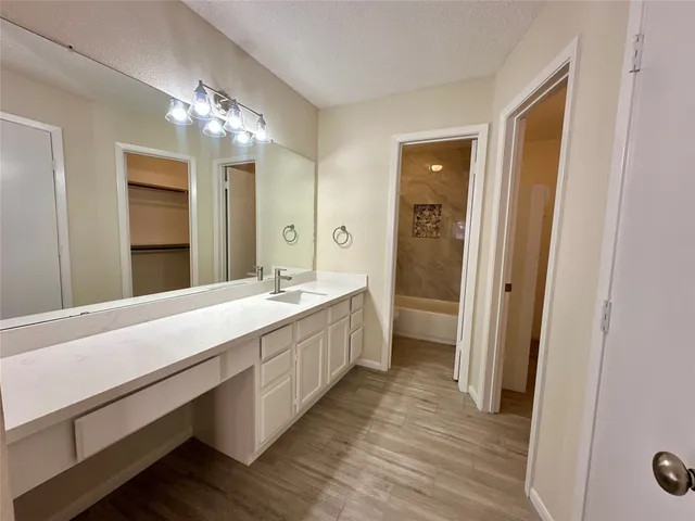 a spacious bathroom with a double vanity sink and a mirror