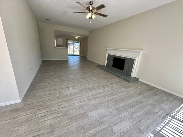 wooden floor in an empty room with a fireplace