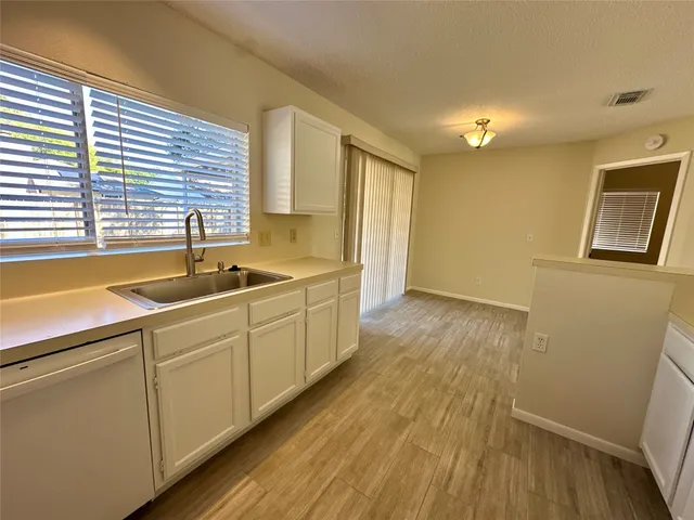 a kitchen with wooden floors and sink