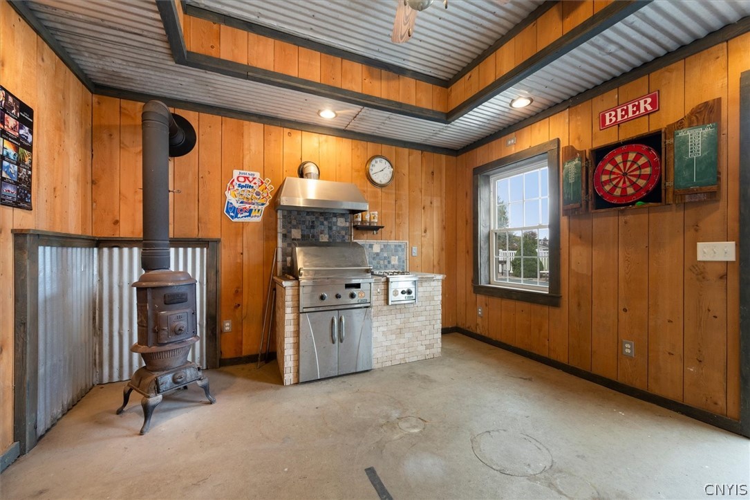 1322 Sawmill Road Sangerfield, NY 13480 - Photo 47 of 50 Rustic wood paneled walls complement the concrete flooring and industrial corrugated metal ceiling accents.