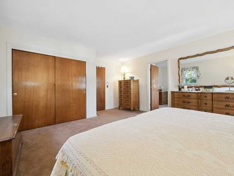 22 Brown Road East Fishkill, NY 12590 - Photo 21 of 37 a spacious bedroom with a large bed and a chandelier