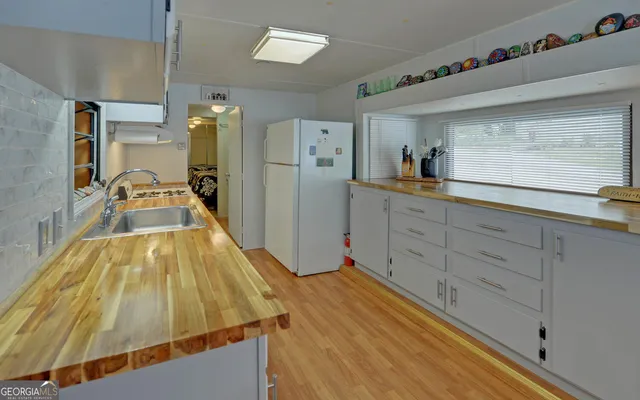 a living room with wooden floor and furniture