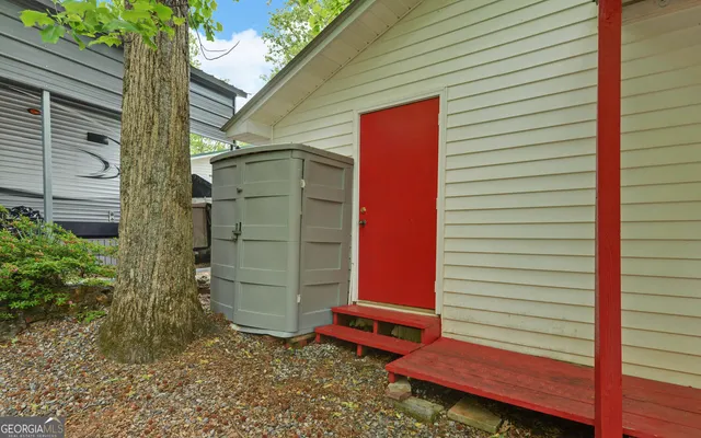 a view of a house with a yard and porch