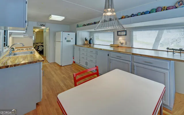 a bedroom with a bed and a large mirror on the dresser