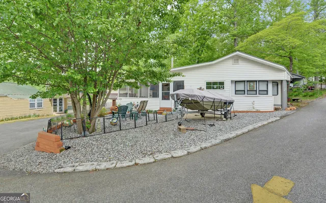 a view of a house with backyard and a tree
