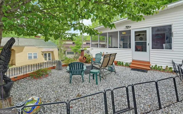 a view of a house with backyard and sitting area