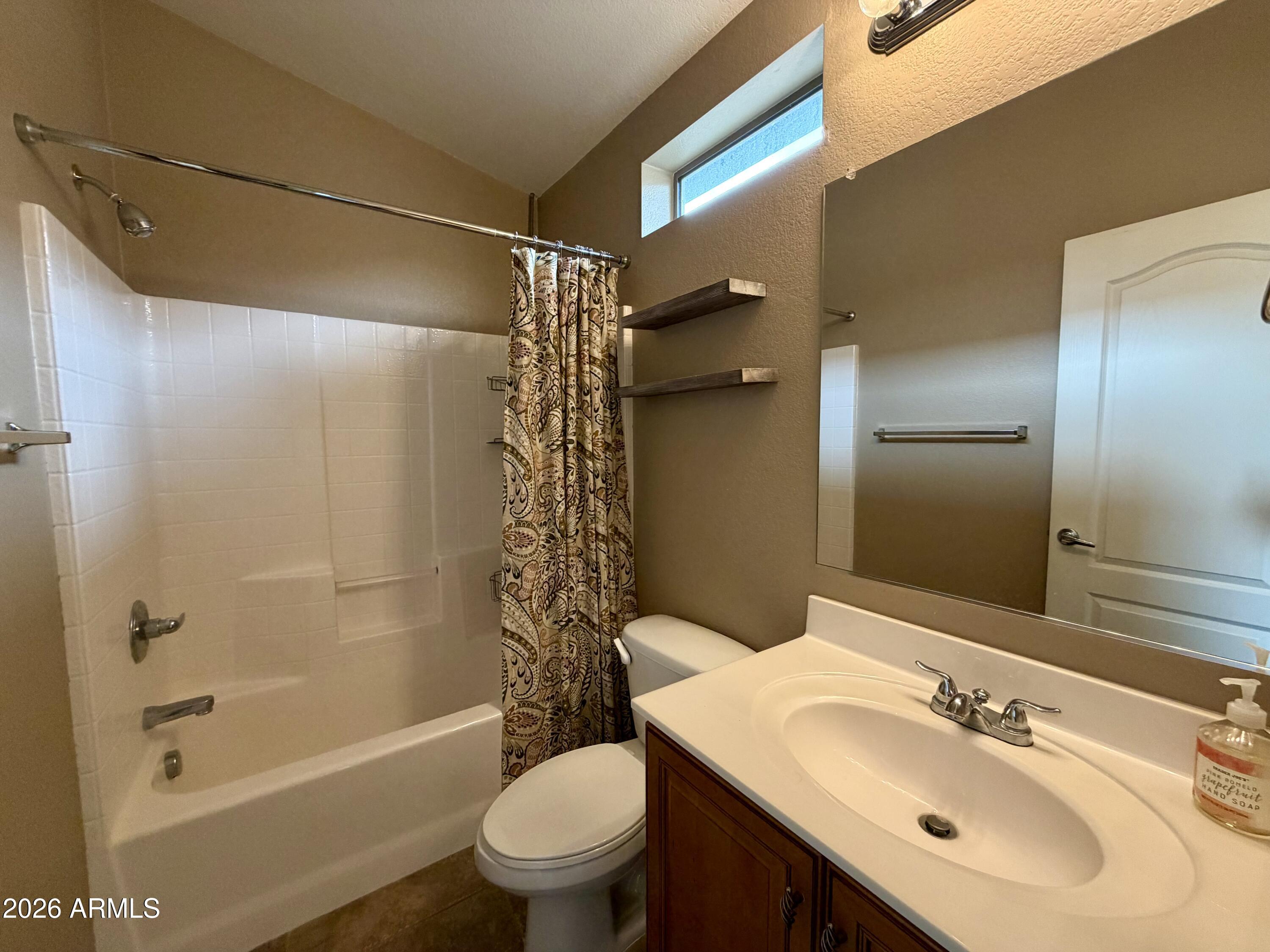 2725 East Mine Creek Road, Unit 2058 Phoenix, AZ 85024 - Photo 13 of 16 a bathroom with a sink mirror toilet and bathtub