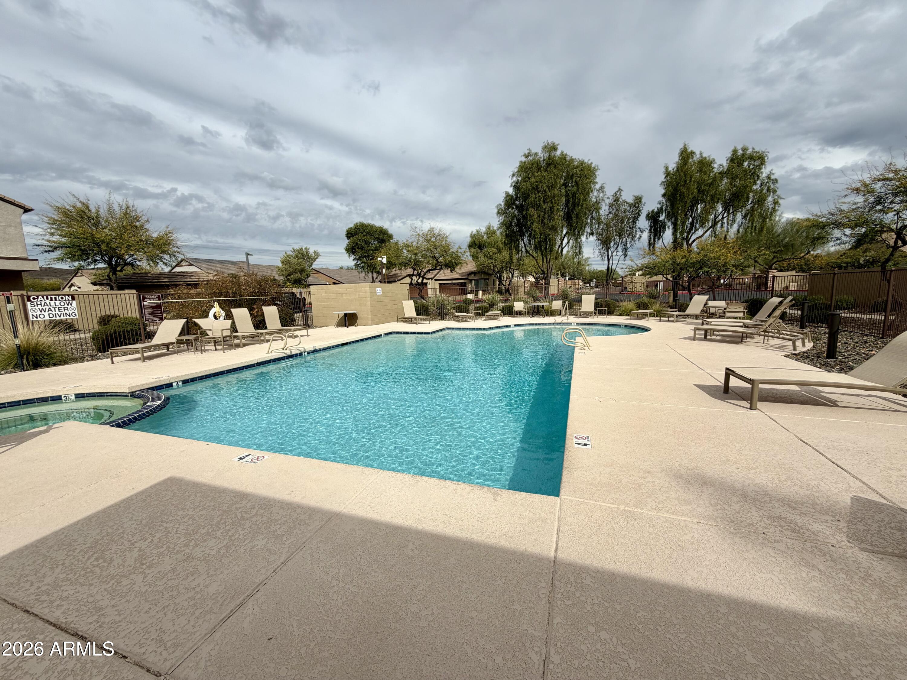 2725 East Mine Creek Road, Unit 2058 Phoenix, AZ 85024 - Photo 15 of 16 a view of a swimming pool and lounge chair
