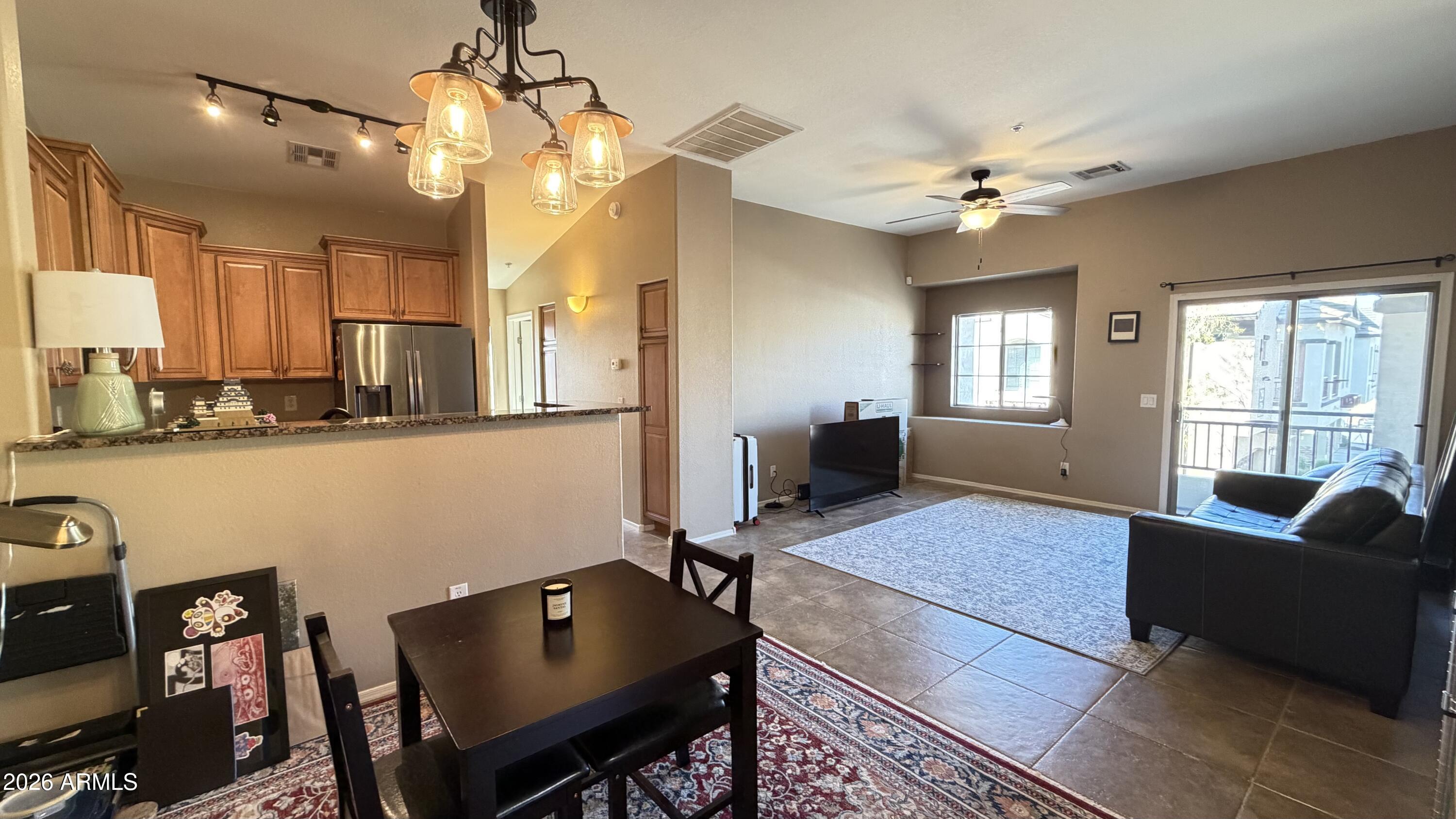 2725 East Mine Creek Road, Unit 2058 Phoenix, AZ 85024 - Photo 2 of 16 a living room with furniture and a chandelier