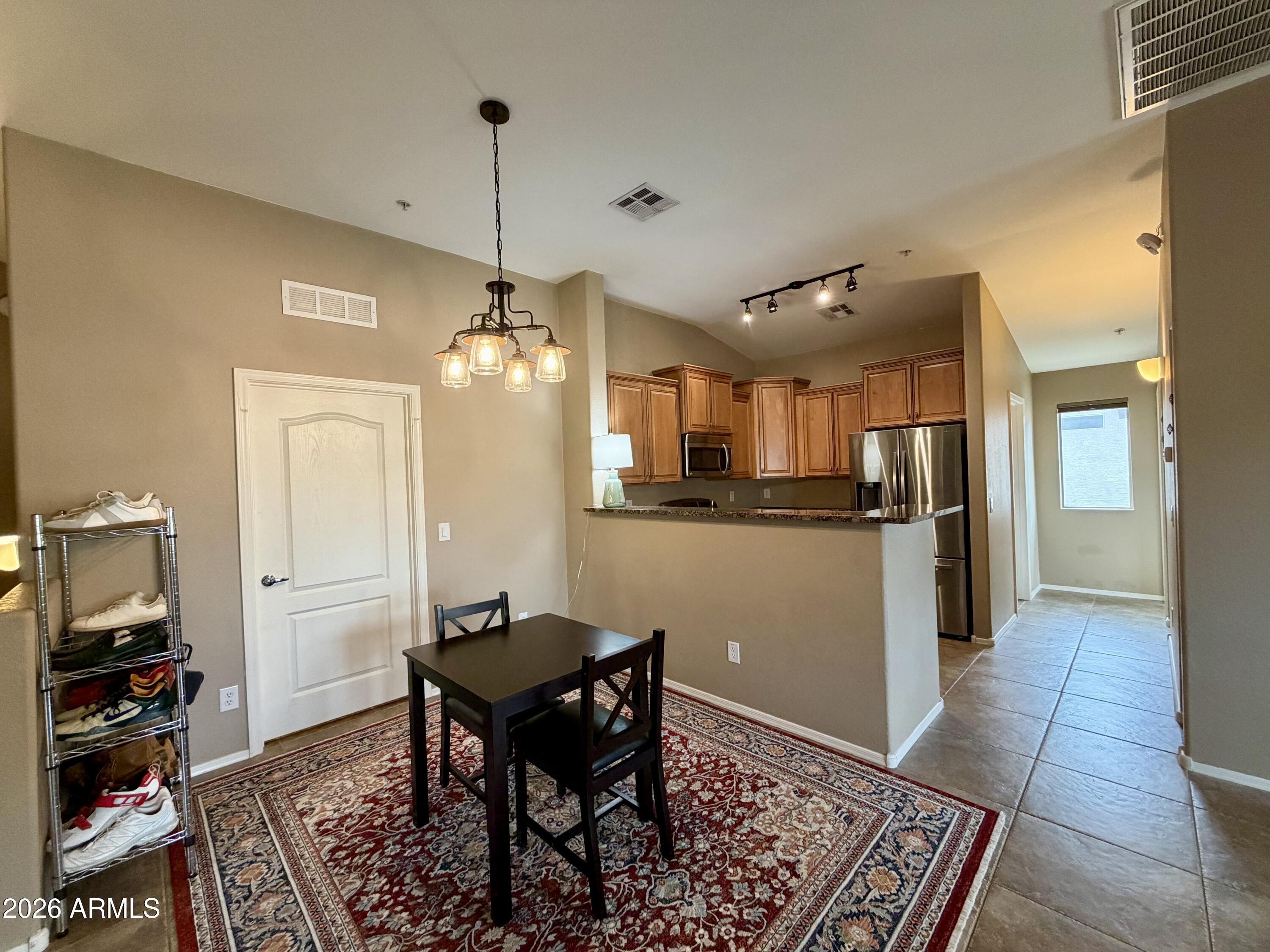 2725 East Mine Creek Road, Unit 2058 Phoenix, AZ 85024 - Photo 3 of 16 a view of a dining room with furniture