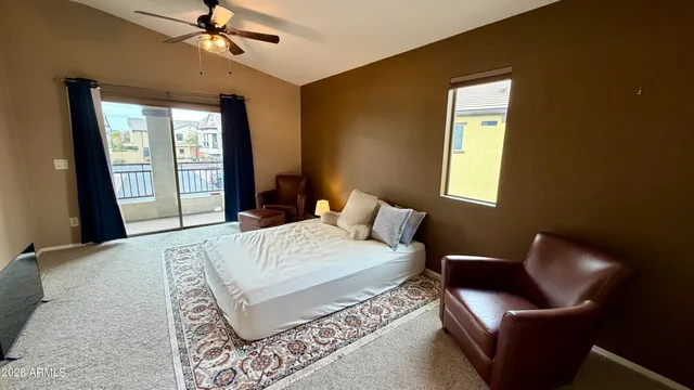 a bedroom with a bed couch and window